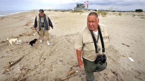 Walter Fuller, right, scans the ocean for wildlife as he walks the beach with friend Roger Poirier.
