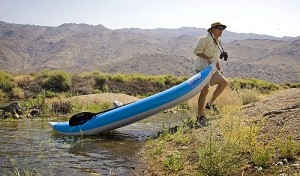 Hill pulls his inflatable kayak out of the water to take a closer look at the new growth that has sprouted in the area since water was redirected into the riverbed.. 