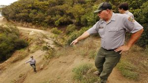 Mike Zenan, right, trail crew leader for Santa Monica Mountains National Recreation Area, works with Neli Navarrete, left, on trail building as crews work to complete the Backbone Trail. 